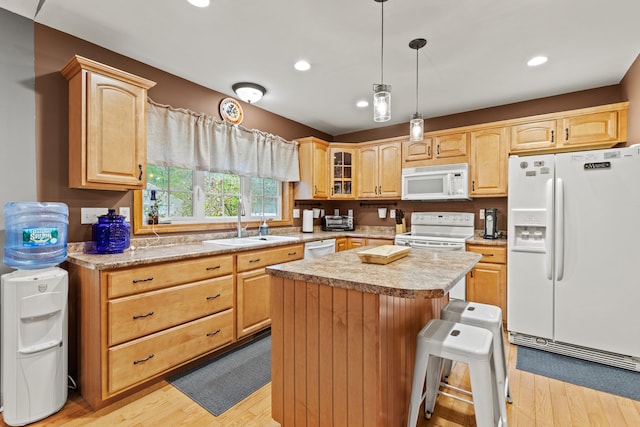214 Gore Rd, Naples, ME 04055 - kitchen with white appliances, a sink, light countertops, light wood finished floors, and a kitchen island