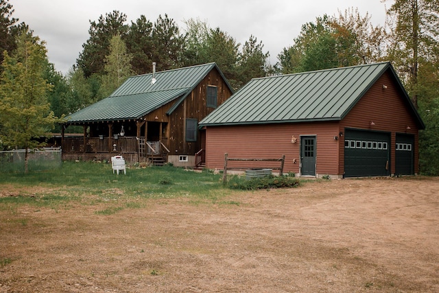 200 Averill Hill Rd, Dixfield, ME 04224 - view of side of home with a standing seam roof, metal roof, a detached garage, and an outdoor structure