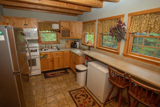 200 Averill Hill Rd, Dixfield, ME 04224 - kitchen featuring white appliances, beamed ceiling, a sink, and light countertops