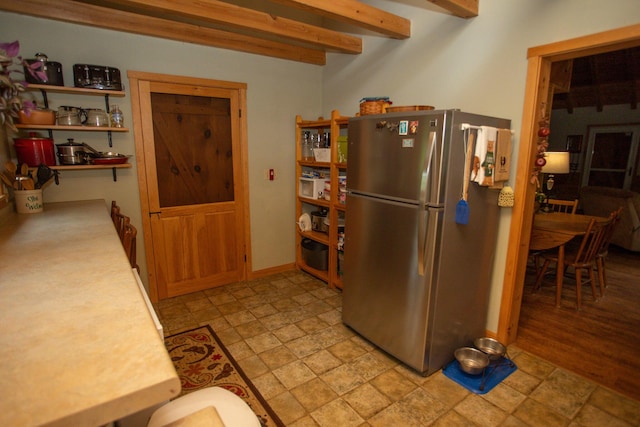 200 Averill Hill Rd, Dixfield, ME 04224 - kitchen with freestanding refrigerator, stone finish floors, light countertops, beamed ceiling, and open shelves