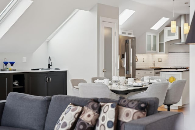 dining area featuring vaulted ceiling with skylight