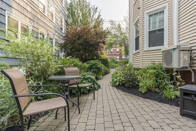 view of property's community featuring a patio area and ac unit