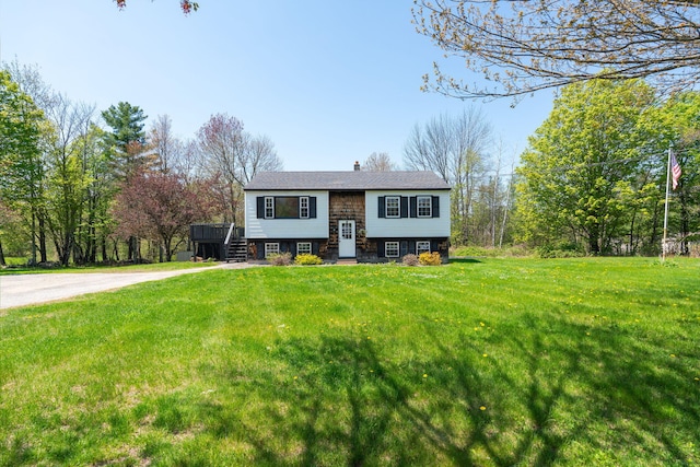 269 Hebron Rd, Buckfield, ME 04220 - split foyer home featuring a front lawn, a chimney, and a wooden deck