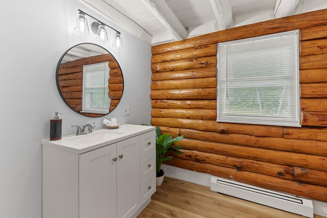 60 Line Rd, Buxton, ME 04093 - bathroom with a baseboard heating unit, vanity, beam ceiling, rustic walls, and wood finished floors
