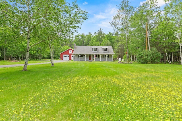60 Line Rd, Buxton, ME 04093 - view of front of home with covered porch, an attached garage, a front yard, and asphalt driveway