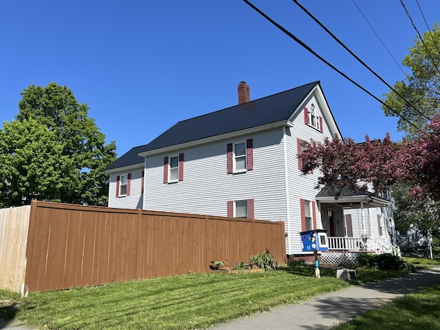 60 Elm St, Bangor, ME 04401 - view of side of property featuring a chimney, a porch, and metal roof