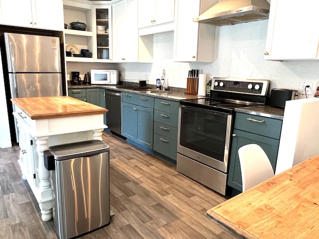 60 Elm St, Bangor, ME 04401 - kitchen featuring stainless steel appliances, wall chimney range hood, wooden counters, and white cabinetry