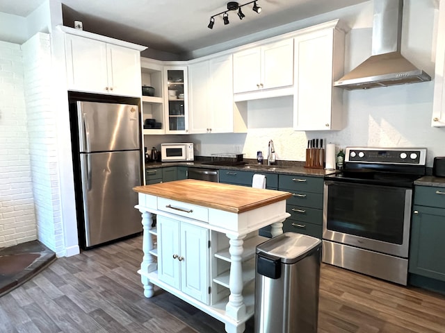 60 Elm St, Bangor, ME 04401 - kitchen featuring open shelves, stainless steel appliances, wall chimney range hood, butcher block countertops, and brick wall