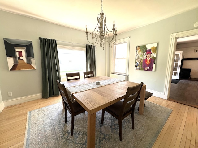 60 Elm St, Bangor, ME 04401 - dining space featuring a chandelier, light wood finished floors, and baseboards