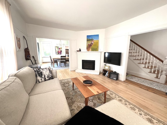 60 Elm St, Bangor, ME 04401 - living room featuring stairs, wood finished floors, and a brick fireplace