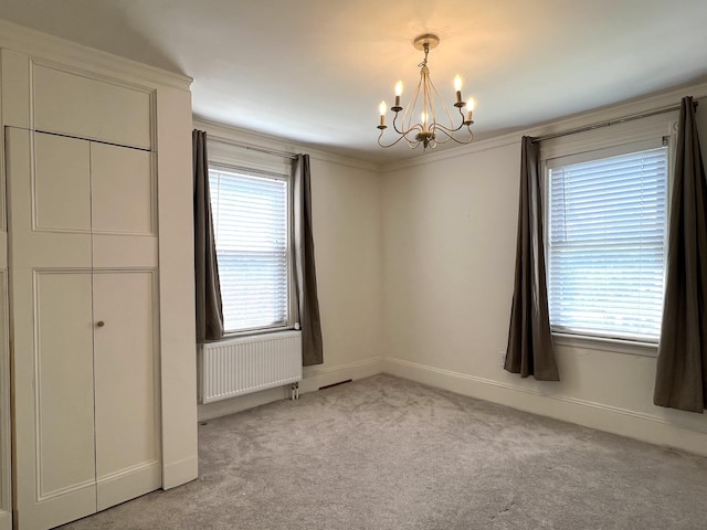 60 Elm St, Bangor, ME 04401 - unfurnished bedroom with radiator heating unit, a chandelier, carpet flooring, and baseboards