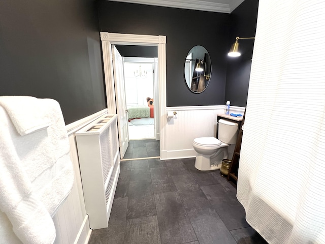 60 Elm St, Bangor, ME 04401 - bathroom featuring toilet, a wainscoted wall, wood-type flooring, ornamental molding, and radiator heating unit