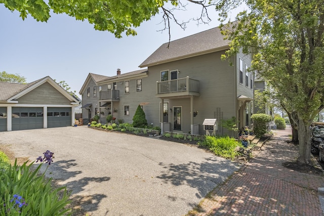 15 Obrion St Unit A, Portland, ME 04101 - view of front facade with a balcony, driveway, and a garage