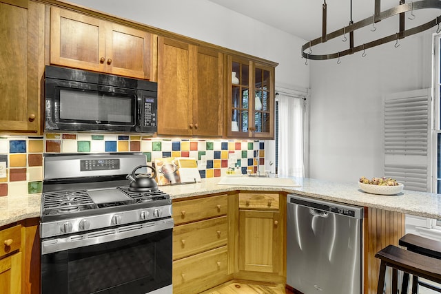 15 Obrion St Unit A, Portland, ME 04101 - kitchen featuring stainless steel appliances, a sink, and light stone countertops