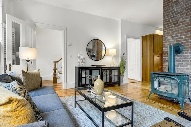 15 Obrion St Unit A, Portland, ME 04101 - living room with a wood stove, light wood-style floors, and baseboards