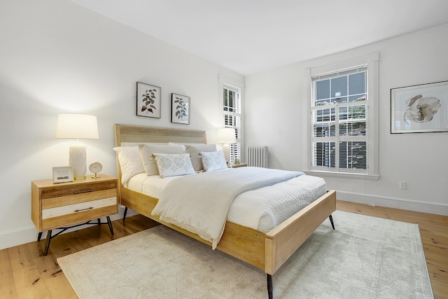 15 Obrion St Unit A, Portland, ME 04101 - bedroom with radiator heating unit, wood finished floors, and baseboards