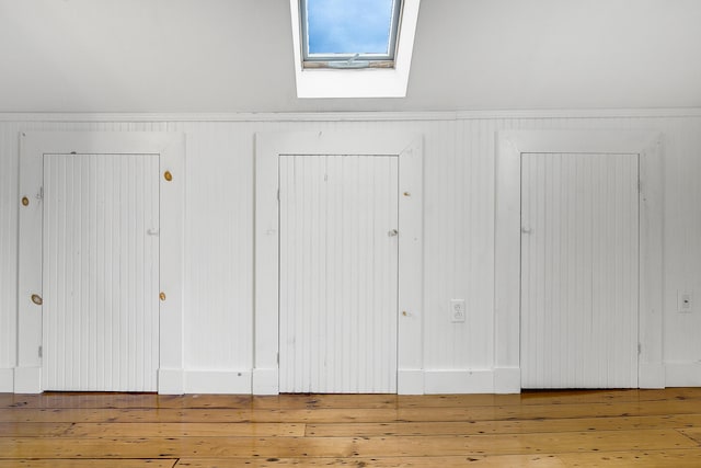 15 Obrion St Unit A, Portland, ME 04101 - detailed view of a skylight, wood finished floors, and a wainscoted wall