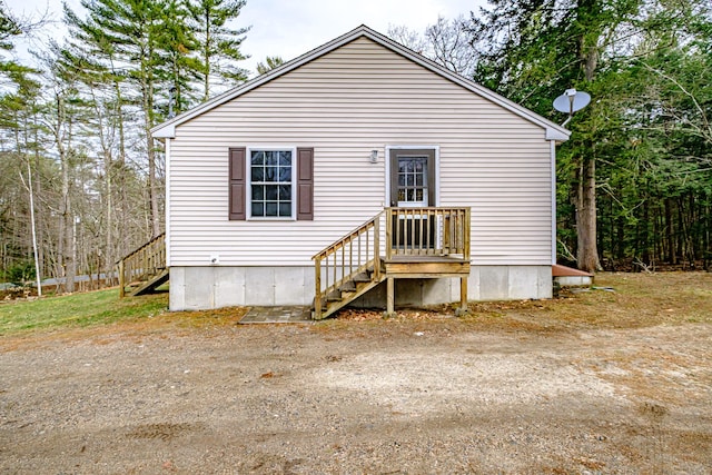 back of house featuring stairway