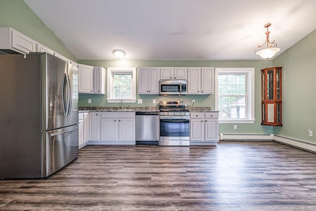 kitchen with stainless steel appliances, dark wood-style floors, a sink, vaulted ceiling, and white cabinetry