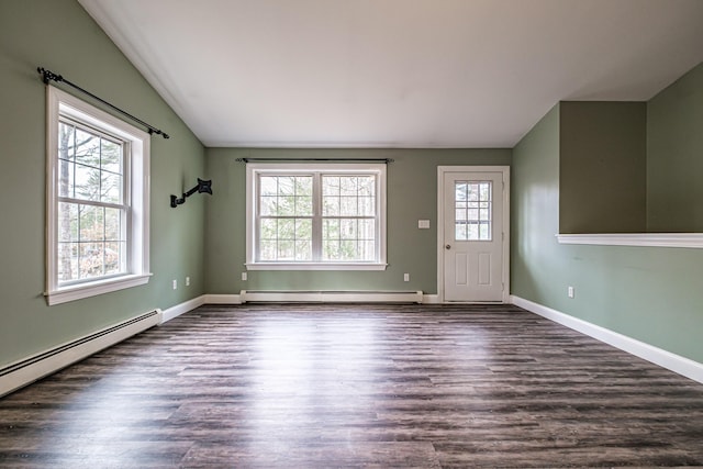 interior space featuring a baseboard radiator, dark wood finished floors, lofted ceiling, and a healthy amount of sunlight