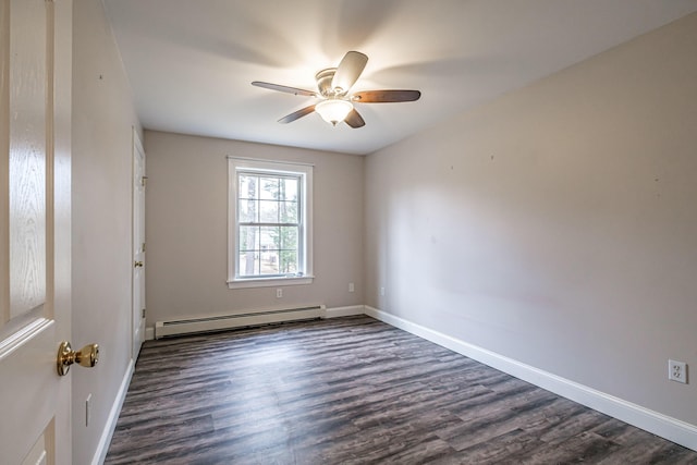 spare room with baseboards, dark wood-style flooring, baseboard heating, and ceiling fan