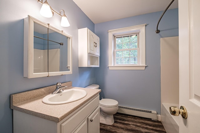 bathroom featuring a baseboard heating unit, wood finished floors, toilet, and vanity
