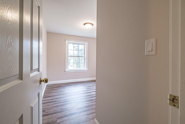 hall with baseboards and dark wood-style floors