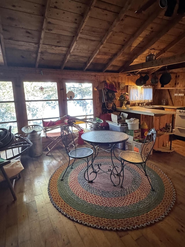 77 Orchard Dr, Saint Albans, ME 04971 - dining space featuring wood-type flooring, wood walls, wooden ceiling, and vaulted ceiling with beams