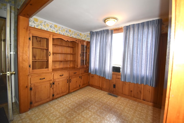 131 George St, Pittsfield, ME 04967 - empty room with ornamental molding, visible vents, and wallpapered walls