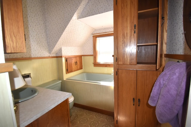 131 George St, Pittsfield, ME 04967 - full bathroom featuring toilet, a garden tub, a wainscoted wall, and wallpapered walls