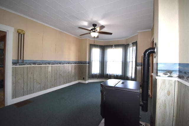 131 George St, Pittsfield, ME 04967 - clothes washing area featuring a ceiling fan, dark carpet, crown molding, washer and clothes dryer, and wooden walls