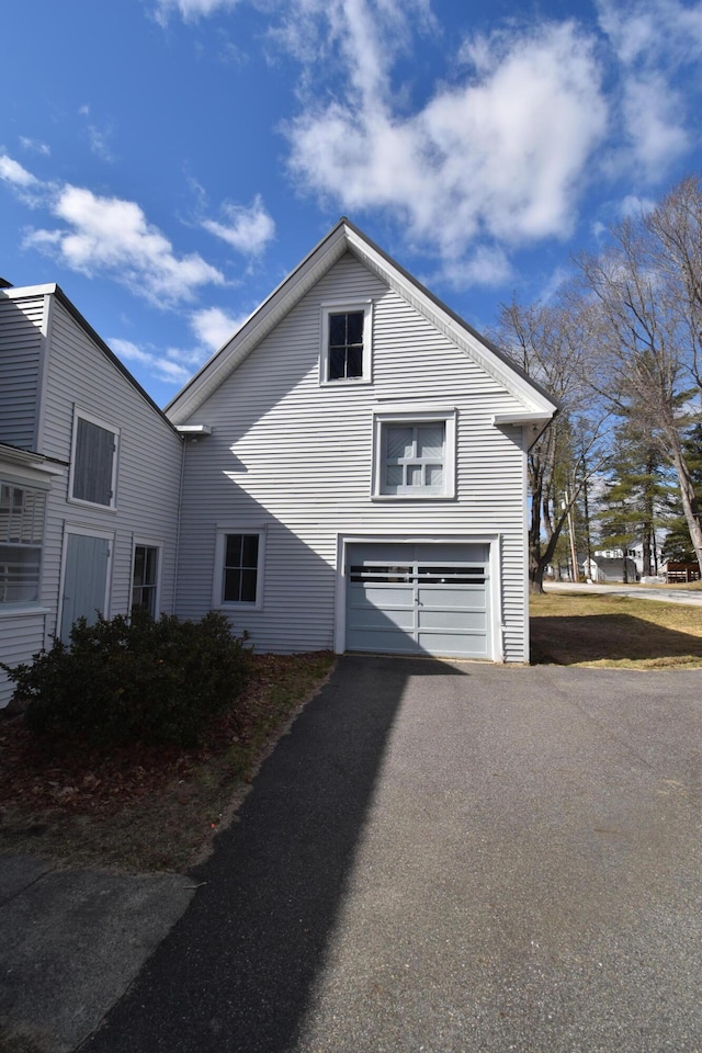 131 George St, Pittsfield, ME 04967 - view of home's exterior with aphalt driveway and a garage