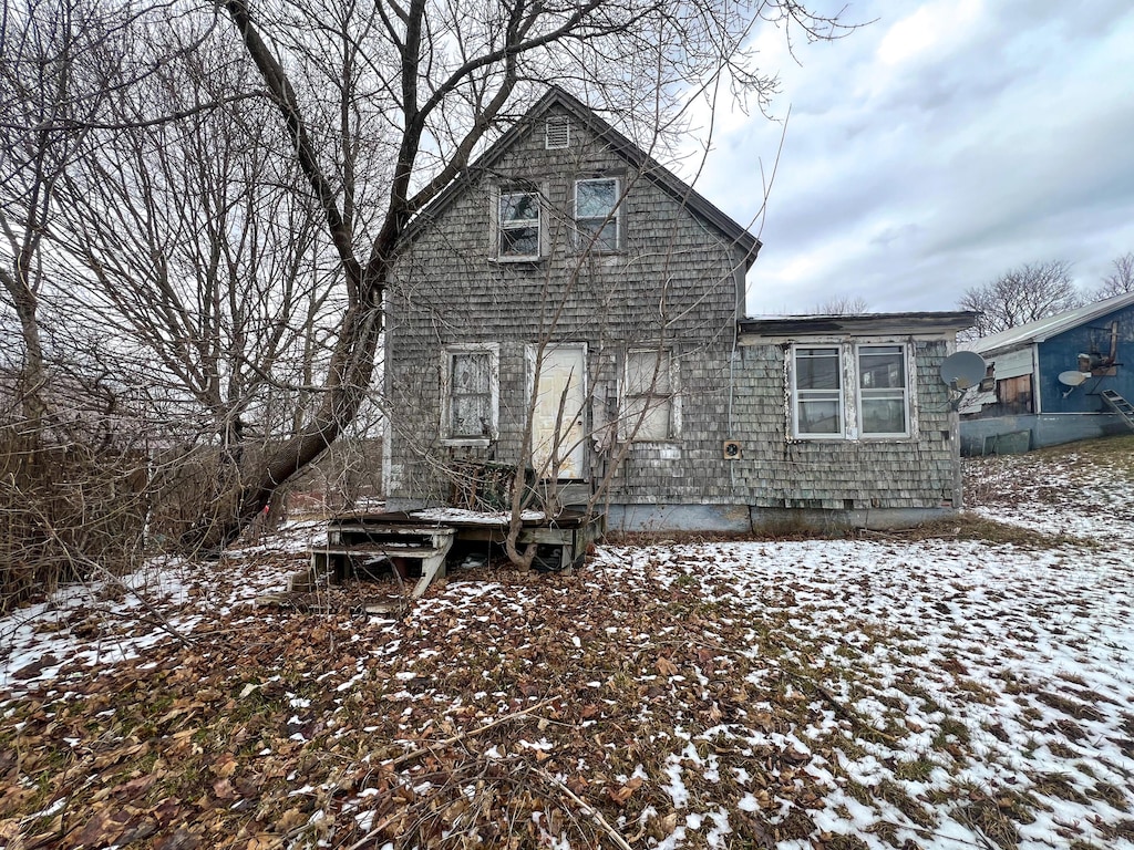 view of snow covered back of property