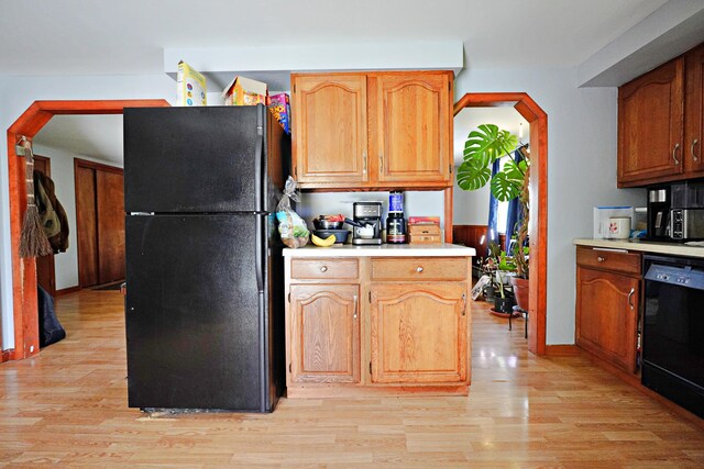 845 Hudson Rd, Glenburn, ME 04401 - kitchen with black appliances, light wood-type flooring, light countertops, and arched walkways