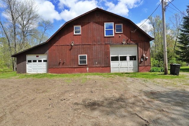 845 Hudson Rd, Glenburn, ME 04401 - view of side of property featuring a detached garage, a barn, driveway, and a gambrel roof