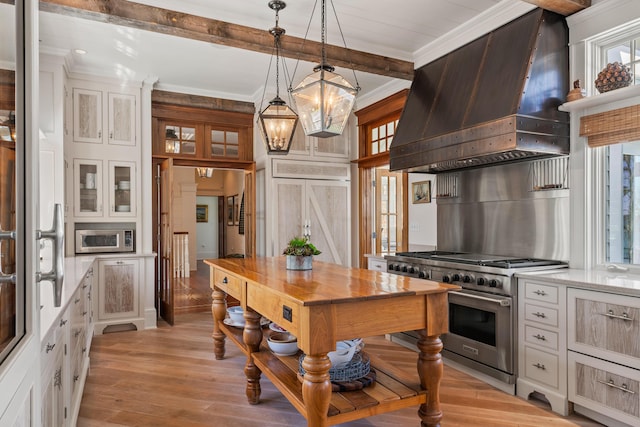 56 Deans Way, Cumberland, ME 04110 - kitchen featuring wall chimney exhaust hood, beam ceiling, crown molding, white cabinetry, and appliances with stainless steel finishes