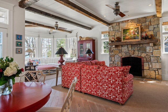 56 Deans Way, Cumberland, ME 04110 - living area with a stone fireplace, beam ceiling, and ceiling fan