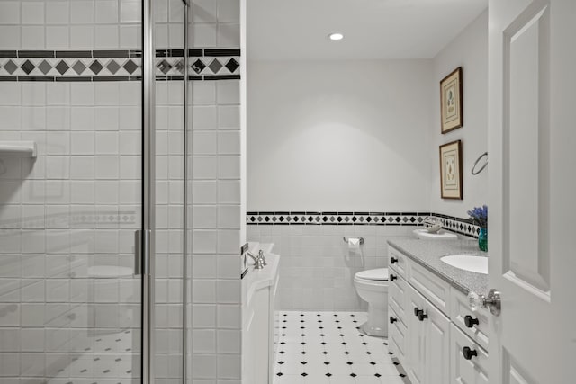 56 Deans Way, Cumberland, ME 04110 - bathroom featuring a stall shower, tile walls, toilet, wainscoting, and vanity