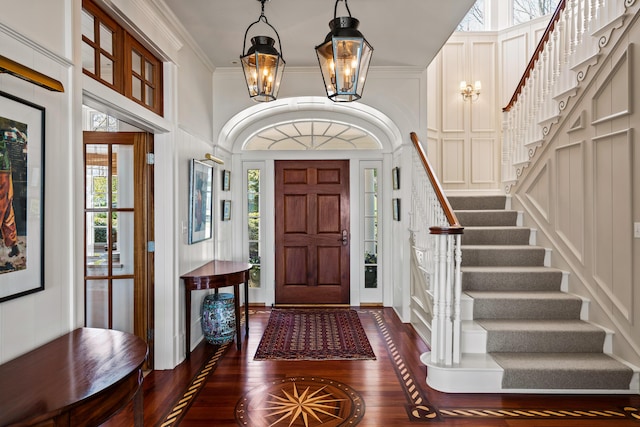 56 Deans Way, Cumberland, ME 04110 - foyer entrance featuring dark wood finished floors, plenty of natural light, a chandelier, and stairs