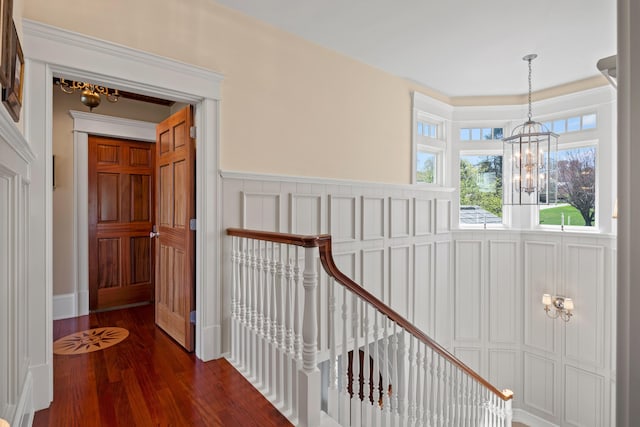 56 Deans Way, Cumberland, ME 04110 - corridor featuring an upstairs landing, a chandelier, a wainscoted wall, and dark wood-type flooring
