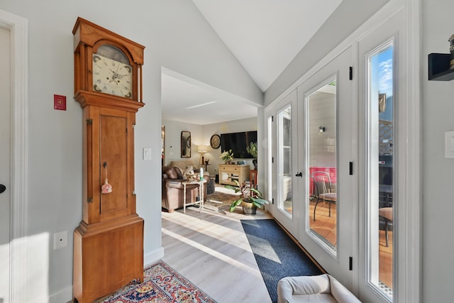 entryway with wood finished floors and lofted ceiling