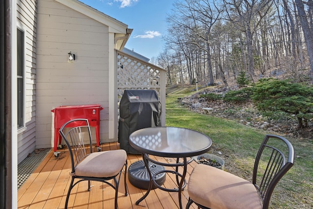wooden deck with a yard and area for grilling