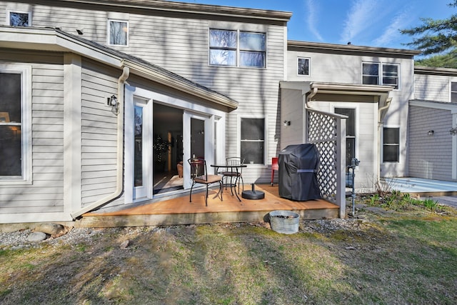 rear view of property featuring a wooden deck