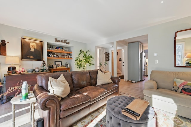 living area featuring light wood-style floors and a dry bar
