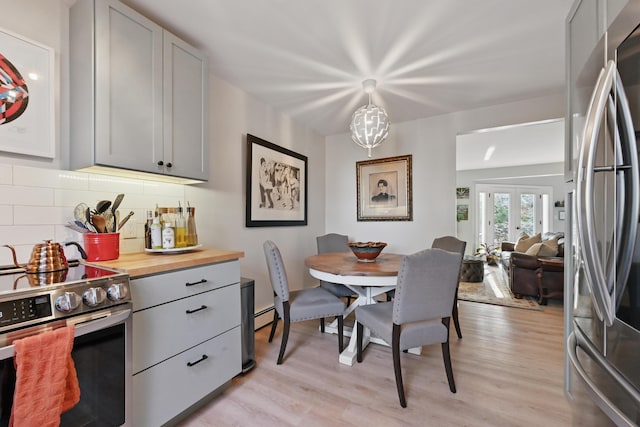dining space featuring light wood-type flooring