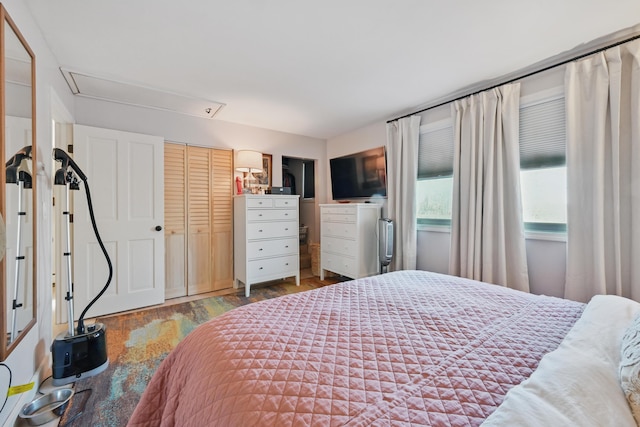 bedroom with attic access and wood finished floors