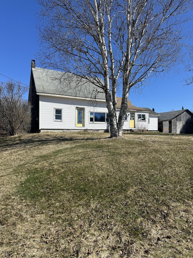 view of front of property with a front lawn and a chimney