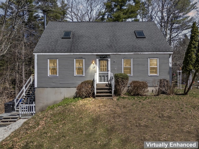 view of front facade with stairs, a shingled roof, and a front lawn