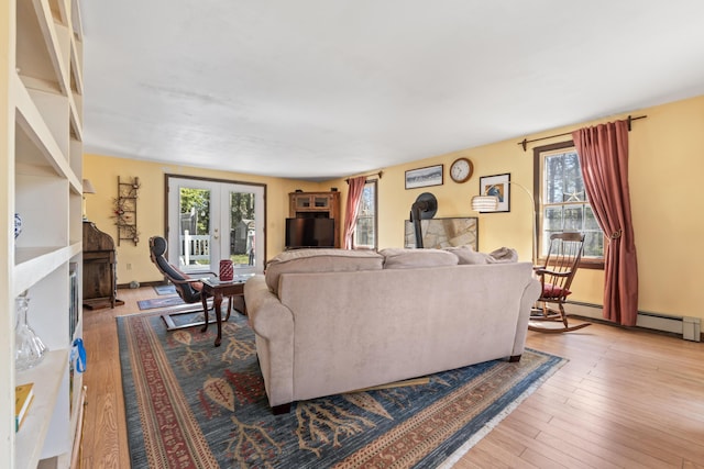 living room with wood finished floors, a fireplace, and a healthy amount of sunlight