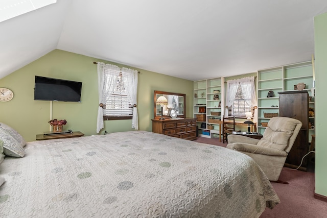bedroom with lofted ceiling with skylight and carpet flooring